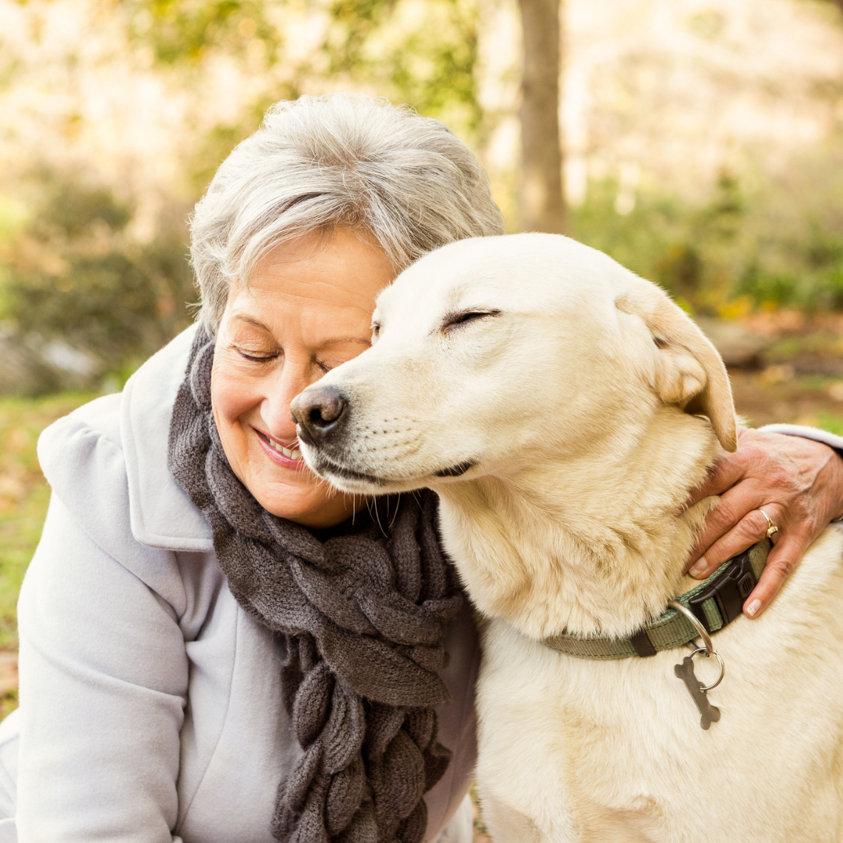 woman in embrace with dog