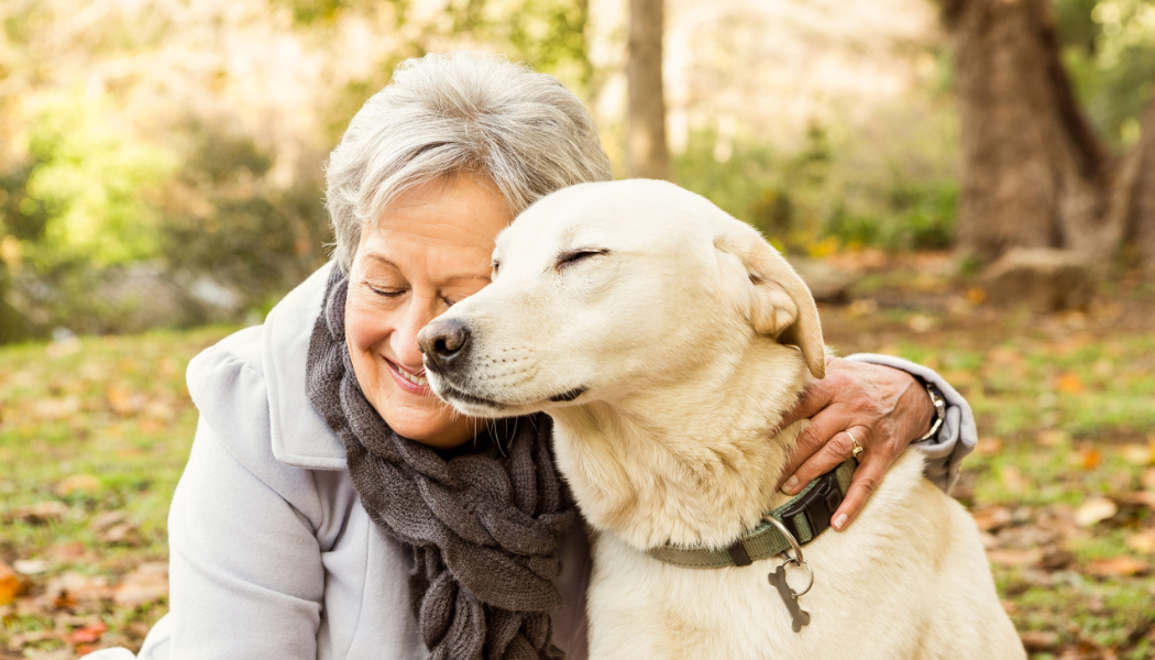 woman and dog in an embrace